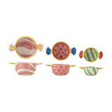 Caramella wrapped sweet Christmas bowls, set of three stoneware bowls with twisted wrapper handles, in pink swirl, pink spot, and green stripe patterns on a white background.