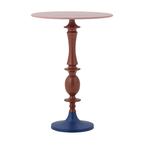 Annan round aluminium side table with a pink top, turned terracotta pedestal stem with a bulbous section, and a navy blue flared disc foot, on a plain white background.