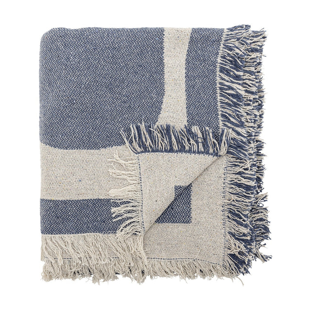 Ethan Cotton Throw in blue, folded to show its bold two-tone graphic pattern and loose fringed edges, cotton-blend fabric, shown on a plain white background.