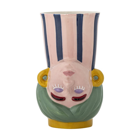 Miss Jody stoneware vase, 22.5cm, shaped as an upside-down face with closed eyes and red lips, green hair base, yellow earring loops and foot, pink neck with navy stripes, on a plain white background.