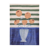 Florinda Wooden Framed Print in Multi, painterly still life of orange flowers in a striped vase against green and white stripes with a blue tabletop band.
