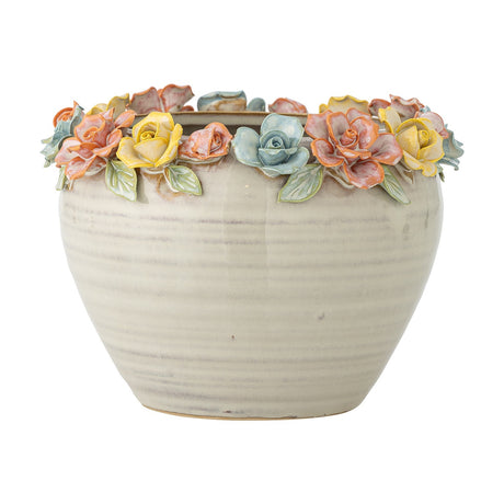 Eanna cream stoneware plant pot with a hand-painted rose garland in yellow, coral and blue around the rim, rounded body, shown on a plain white background.