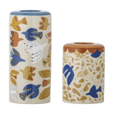 Set of 2 cylindrical stoneware candle holders with colourful bird and floral illustrations, one tall with a blue rim, one short with a rust scalloped rim, on white background.