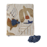 Anniversary Cotton Throw in multicoloured bird and wing print, folded with navy corner tassels and striped reverse, shown on a plain white background.