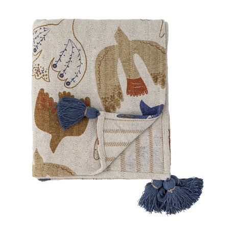 Anniversary Cotton Throw in multicoloured bird and wing print, folded with navy corner tassels and striped reverse, shown on a plain white background.