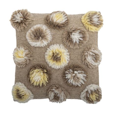 Somma Wool Cushion in Natural, a 50x50cm square cushion with shaggy tufted rosettes in beige, cream and yellow across a woven ground, shown on a white background.