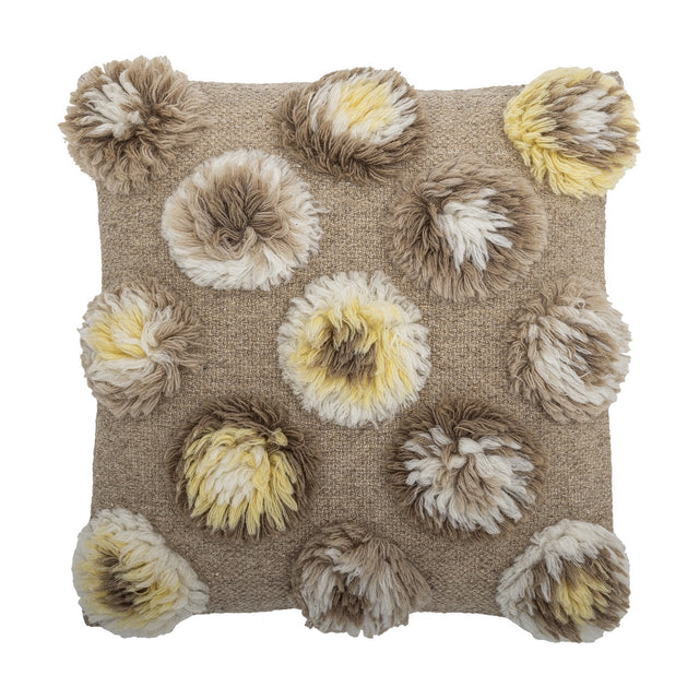 Somma Wool Cushion in Natural, a 50x50cm square cushion with shaggy tufted rosettes in beige, cream and yellow across a woven ground, shown on a white background.