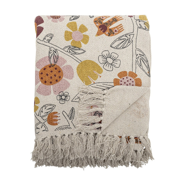 Vivielle Floral Throw in multicoloured cotton-blend fabric, folded to show an open flower, leaf and bird print with long knotted fringe, on a plain white background.