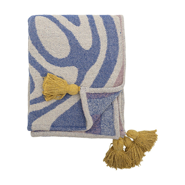 Arlie Throw in blue, folded woven fabric with a bold swirling stripe pattern and mustard-yellow tassels at the corners, shown against a plain white background.
