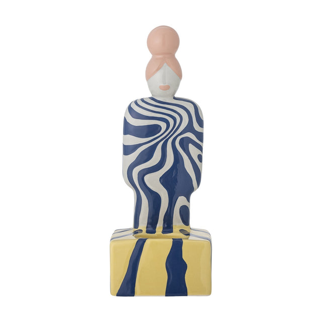 Priya Stoneware Tealight Holder in Multi, a ceramic figure with a pink bun, blue-and-white swirl patterned body, standing on a yellow and navy striped block base, shown on a plain white background.