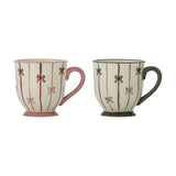 Hope Striped Stoneware Christmas Mugs, set of 2, footed stoneware mugs with curved handles in pink and green, hand-painted vertical stripes and bow motifs, on a white background.