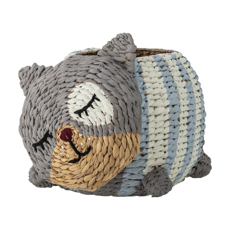 Mille Water Hyacinth Basket shaped like a sleeping cat with woven grey, tan and blue-striped body, embroidered eyes, pointed ears and tail, on a plain white background.