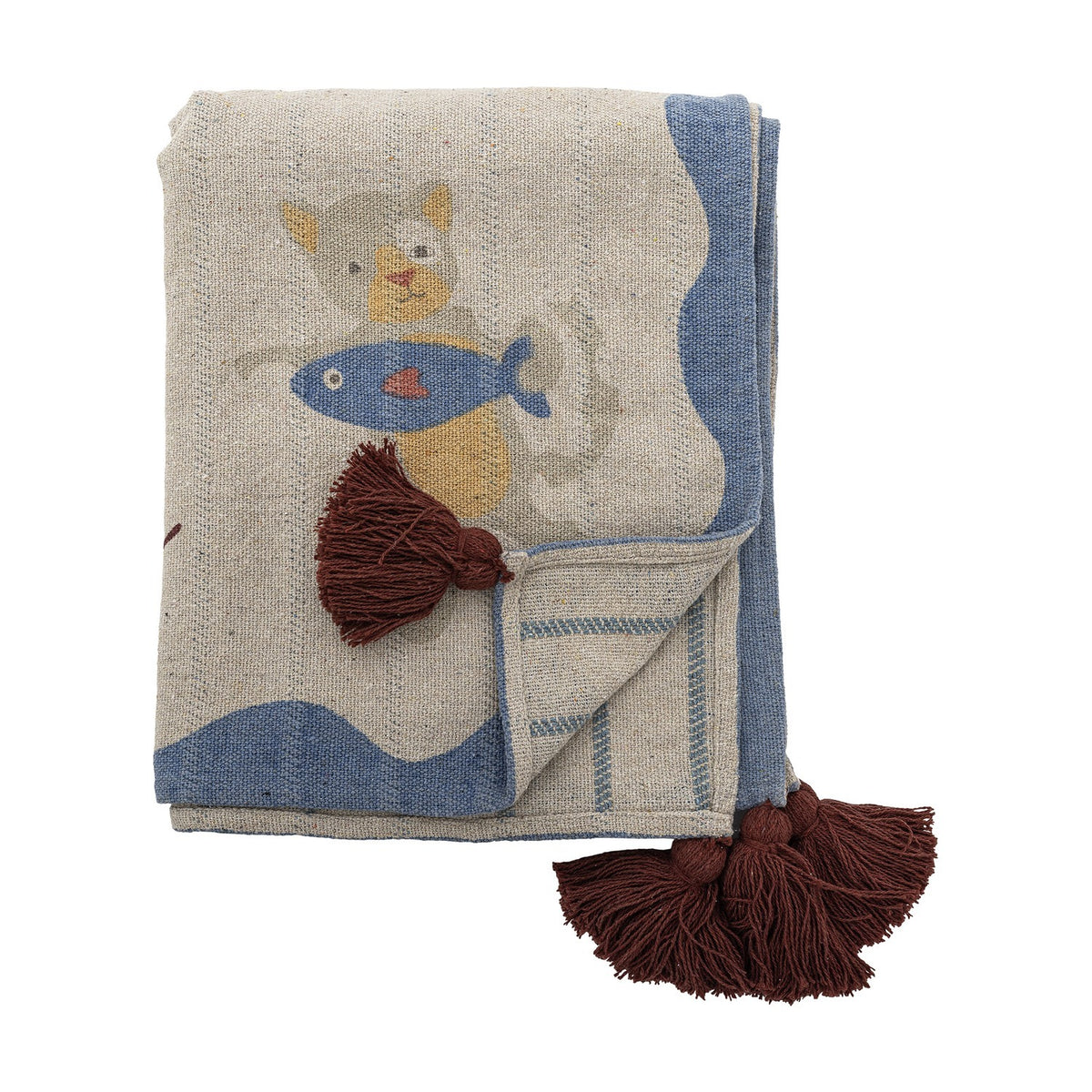 Mille Cotton Throw in beige, folded cotton blanket printed with a cat holding a fish, wavy blue border, striped reverse, and brown corner tassels, on a white background.