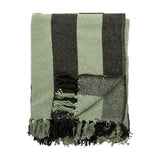 Frello Striped Cotton Throw in Green, folded with broad woven stripes in pale and deep green and knotted fringe tassels, shown on a white background.