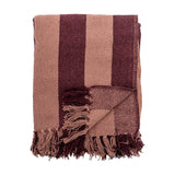 Frello Striped Cotton Throw in red, folded with wide stripes in light and deep red tones and knotted fringe tassels, shown on a plain white background.