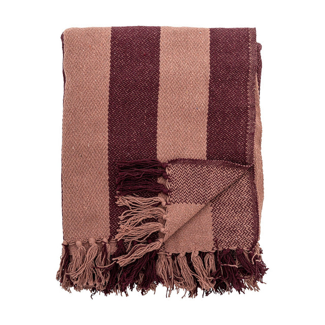 Frello Striped Cotton Throw in red, folded with wide stripes in light and deep red tones and knotted fringe tassels, shown on a plain white background.