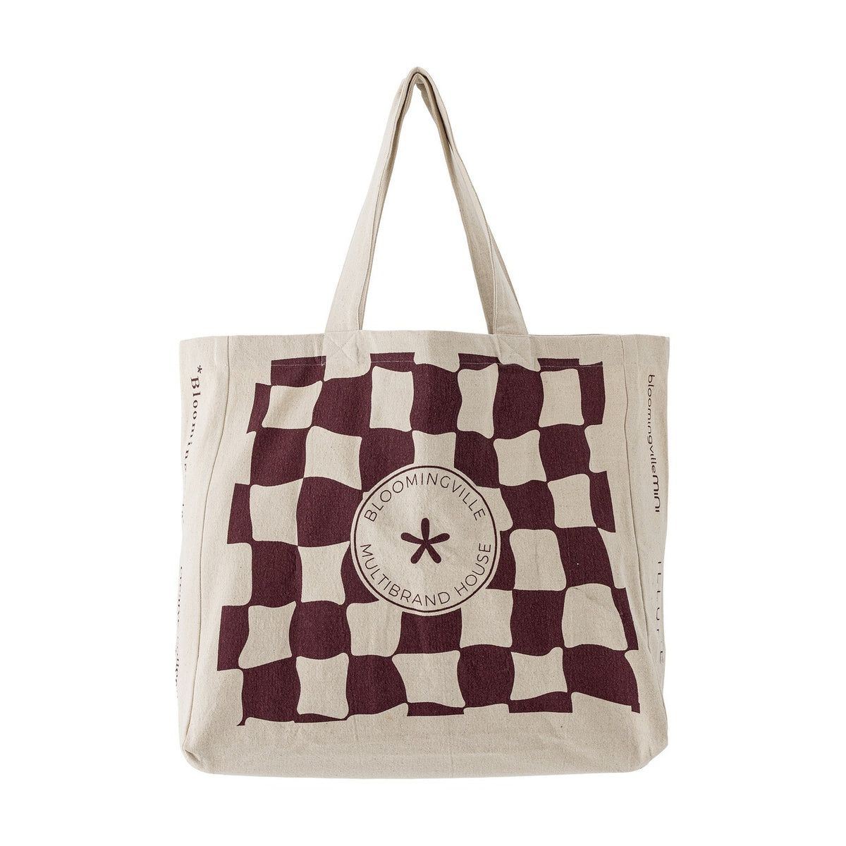 Beige cotton shopping tote with a wavy maroon check pattern and round "Bloomingville Multibrand House" badge at centre, shown on a plain white background.