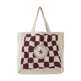 Beige cotton shopping tote with a wavy maroon check pattern and round "Bloomingville Multibrand House" badge at centre, shown on a plain white background.