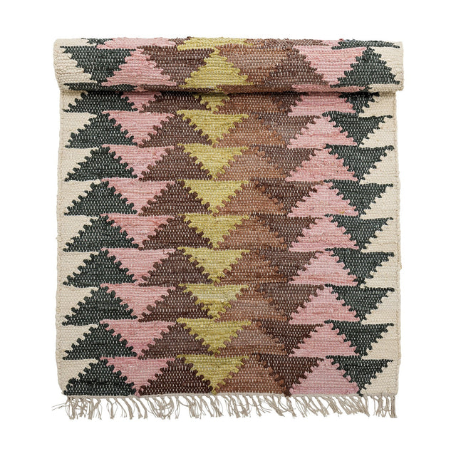 Desmond Geometric Cotton Rug, 180x80cm, with a mirrored triangle pattern in pink, mustard, brown and dark green on cream, fringed edges, shown rolled at the top on a white background.