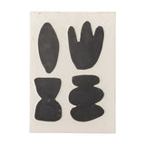 Lutton Stoneware Wall Decor in white, a rectangular ceramic panel with four dark organic shapes—a leaf, a budded form, an hourglass and stacked pebbles—on a plain background.