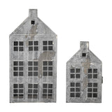 Heidrun House iron Christmas lanterns, set of 2, townhouse-shaped candle holders with pitched roofs, chimneys and paned windows in a weathered grey finish on a white background.
