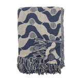 Santena Wavy Cotton Throw in blue, folded, showing a textured woven wave pattern with dotted circles and fringed edges, against a plain white background.