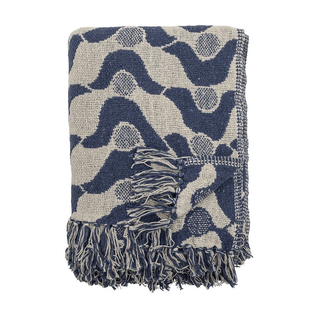 Santena Wavy Cotton Throw in blue, folded, showing a textured woven wave pattern with dotted circles and fringed edges, against a plain white background.
