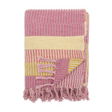 Isnel Striped Throw in Pink, folded to show a woven textured stripe pattern in pink, yellow and grey with knotted tassel fringe, on a plain white background.