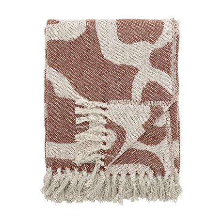 Salobre Cotton Throw in brown, folded to show an abstract organic pattern in woven cotton blend with cream fringed edges, on a plain white background.