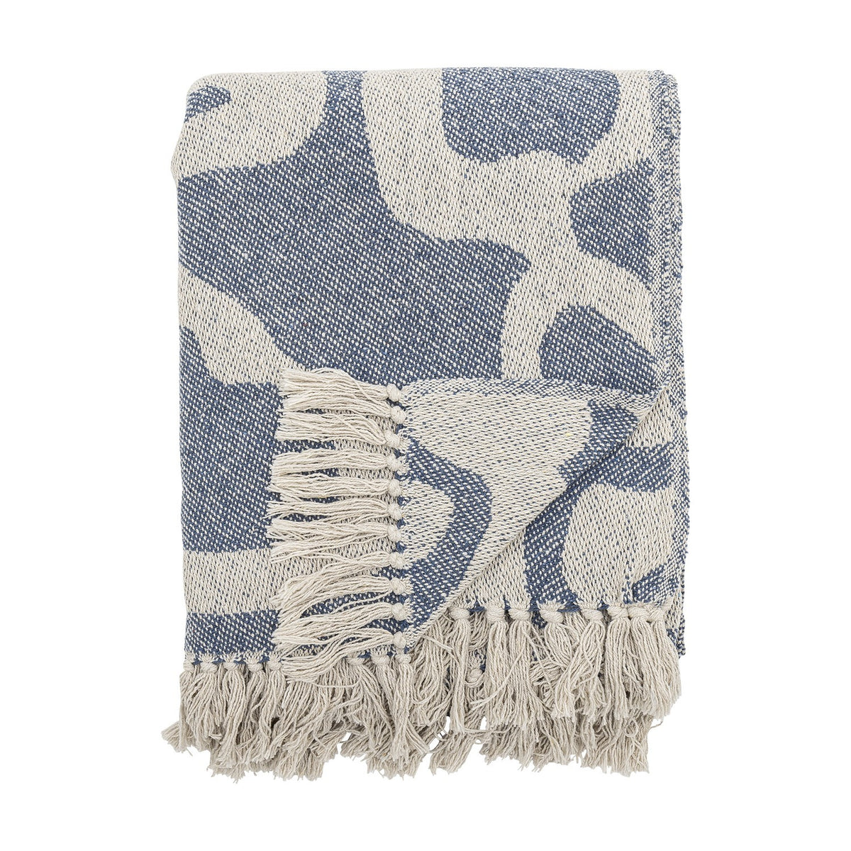 Salobre Cotton Throw in blue, folded showing an abstract flowing pattern in off-white with matching knotted fringe, shown on a plain white background.