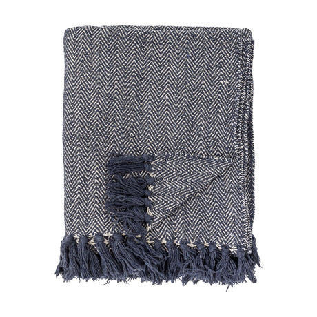 Folded Herringbone Throw in blue with woven zigzag pattern and knotted fringe edge, shown on a plain white background.