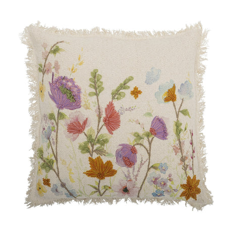 Pogni Floral Cotton Cushion in Natural, square with fringed edges, featuring raised embroidered wildflowers in purple, orange and coral over a cream cotton cover, shown on a white background.