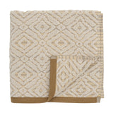 Malou Cotton Towel in Natural, folded hand towel with a woven geometric diamond pattern in cream and mustard, finished with a mustard-brown edge trim, on a white background.