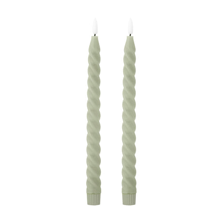 Pair of Ponza LED taper candles in green paraffin wax with a spiral-twist body, fluted base, and flame-shaped tip, shown on a plain white background.