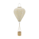 Pomp Floral Baby Mobile in yellow, a hot air balloon-shaped hanging decoration with ribbed fabric panels and small floral pattern, paired with a woven basket, shown on a plain white background.