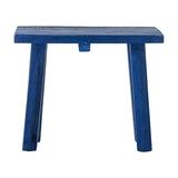Porir Wooden Pedestal in blue, a small rustic stool-like stand with a rectangular top on four splayed legs, reclaimed wood with painted finish, shown on a plain white background.