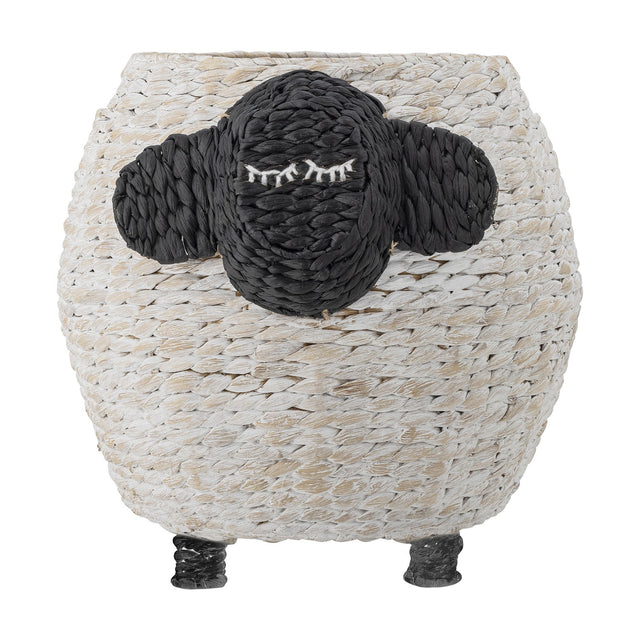 Dolly Sheep Water Hyacinth Basket in white, a round woven storage basket with a black sheep face, stitched sleepy eyes, two ears, and short raised legs, on a plain white background.