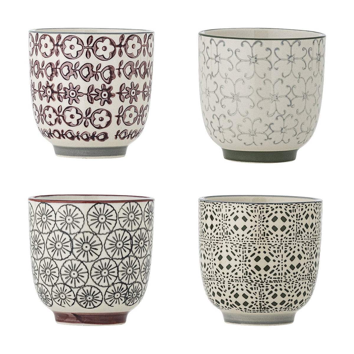 Karine Floral Stoneware Cups, set of four handleless ceramic cups in cream with hand-stamped floral and geometric patterns in burgundy, grey, and black, each with a contrasting rim line.