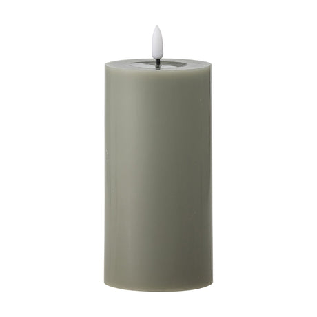 Ponza LED Candle in green, a 15cm paraffin pillar candle with a flame-shaped tip set in a shallow top dip, shown on a plain white background.