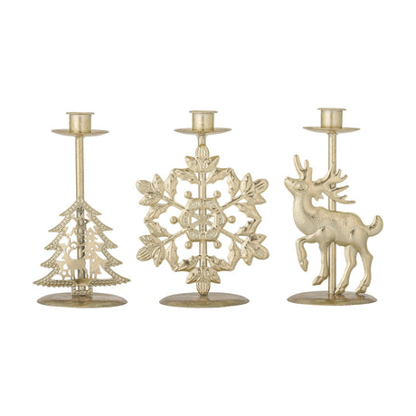 Set of three gold metal Christmas candle holders with oval bases, featuring fretwork tree, snowflake, and stag motifs, on a plain white background.