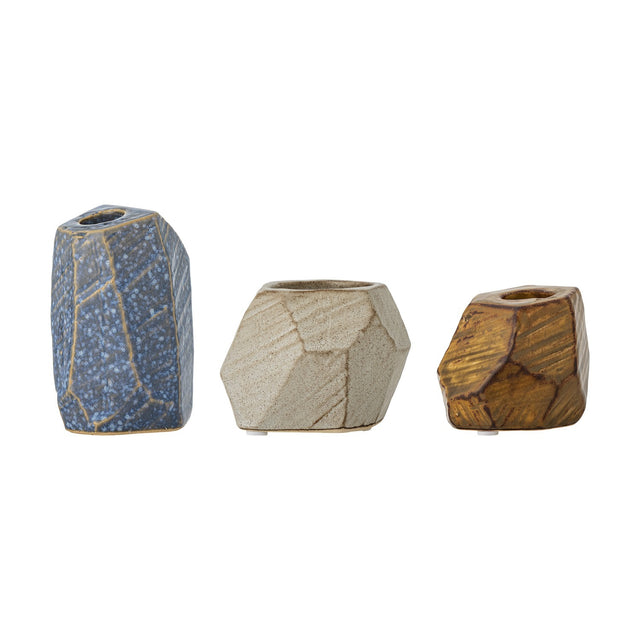 Kimber Stoneware Tealight & Candle Holders, set of three faceted stone-like vessels in blue, cream and amber glazes, shown on a plain white background.