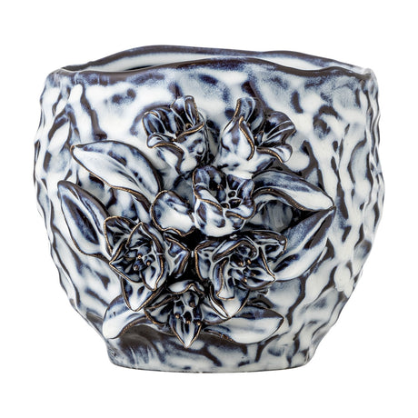 Malina Floral Stoneware Plant Pot in blue with a rippled, crinkled texture and a raised floral and leaf cluster in relief on one side, shown on a plain white background.