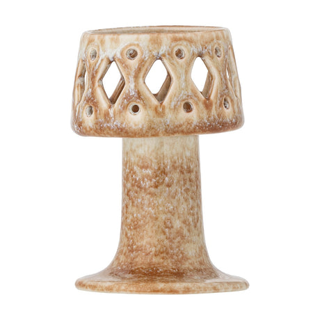 Patty Stoneware Tealight Holder in beige, a pedestal design with a pierced cup featuring diamond cut-outs and round holes above a slim stem and flared foot, shown on a white background.