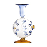 Phila Glass Candle Holder in Blue, shaped like a puffer fish with a clear round body, blue glass spines, an amber fin and base, and a flared blue cup top, on a plain white background.