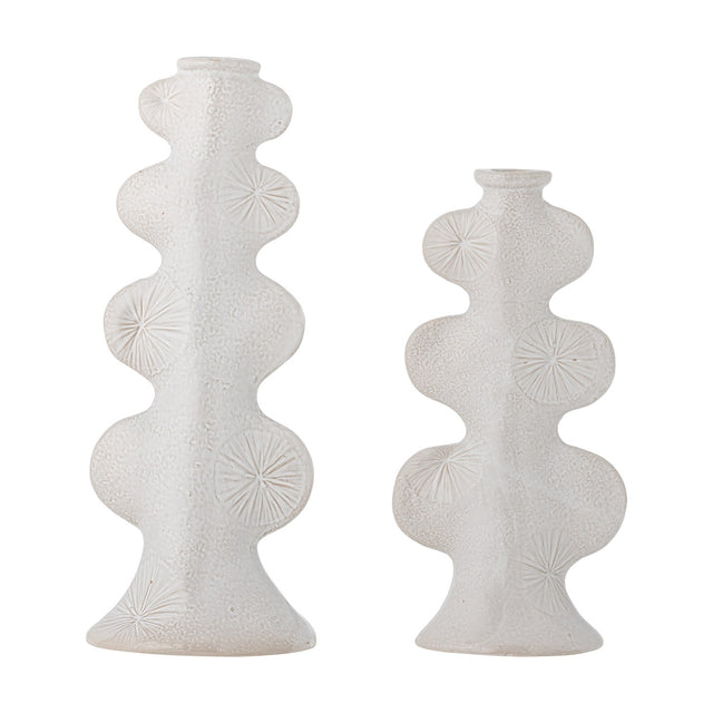 Cason stoneware candle holders in white, set of two different heights with rounded lobed columns, flared feet, narrow collars, and sunburst motifs on a textured glaze, shown on a plain background.
