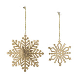 Set of two gold iron Kanja Christmas tree decorations with lacquer finish, a larger six-arm snowflake and a smaller diamond-outlined one, hung on twisted cord.