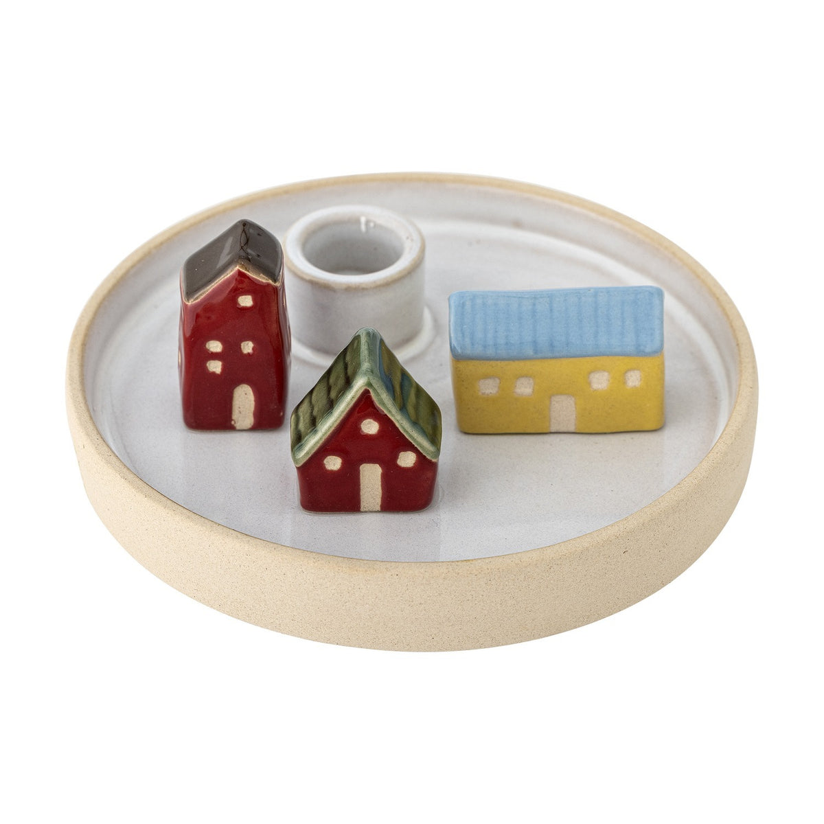 Coze round stoneware candle holder with a shallow rimmed base and central taper cup, surrounded by three glazed miniature houses in red, yellow, and blue, shown on a plain white background.