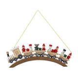 Bertie wooden Christmas tree decoration in beige, a steam train on an arched base carrying snowmen, bobble-hat figures and a bear, hung on gold string against a white background.