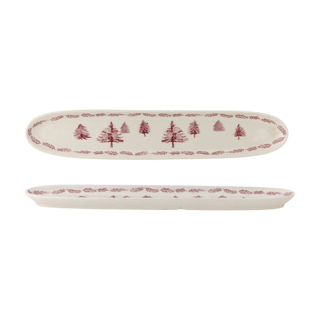 Wonderland Stoneware Christmas Platter in cream, a long narrow oval dish with rounded ends, decorated with a row of pine trees and a pine-branch border, shown top and side view on a white background.