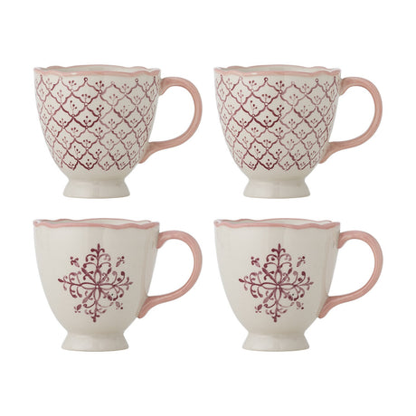 Set of 4 stoneware Wonderland Christmas mugs, 525ml, cream with pink scalloped rims and handles, two in a diamond trellis pattern and two with a pink floral motif, footed bases, on a white background.